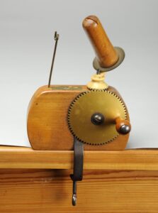 Wooden ball winder with brass cog wheel