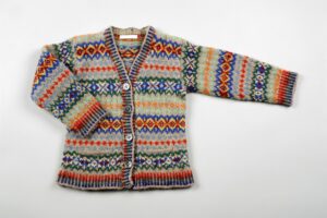 Child's Fair Isle brightly coloured knitted cardigan with stranded rib welt, cuffs and button/neck band and geometrical motifs in stripes.
