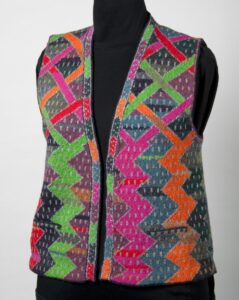 Brightly coloured knitted waistcoat with vertical zig-zag design.