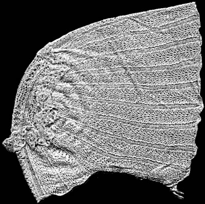 Knitted cap - the front is at the bottom of the image. Knitted with columns of openwork.