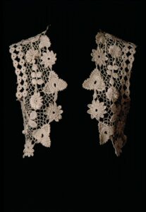 Irish crochet bolero with flowers and leaves on an open lattice.