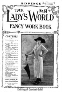 Cover of Lady's World Fancy Work book showing lady in long knitted dress and knitted cardigan holding umbrella and wearing a feathered hat.