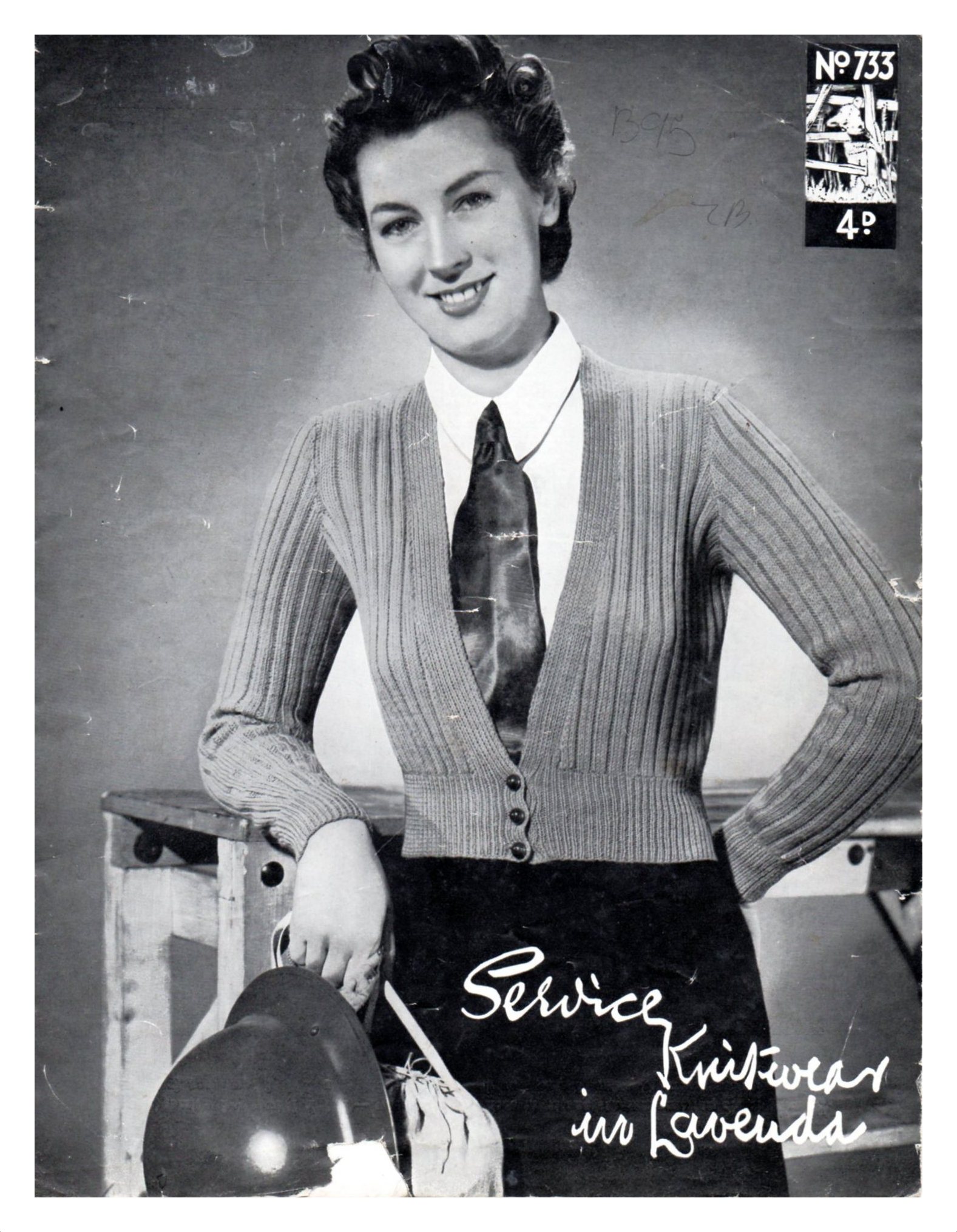 Cover of Service Knitwear in Lavenda showing lady wearing ribbed cardigan with low and wide neckline to show a tie.