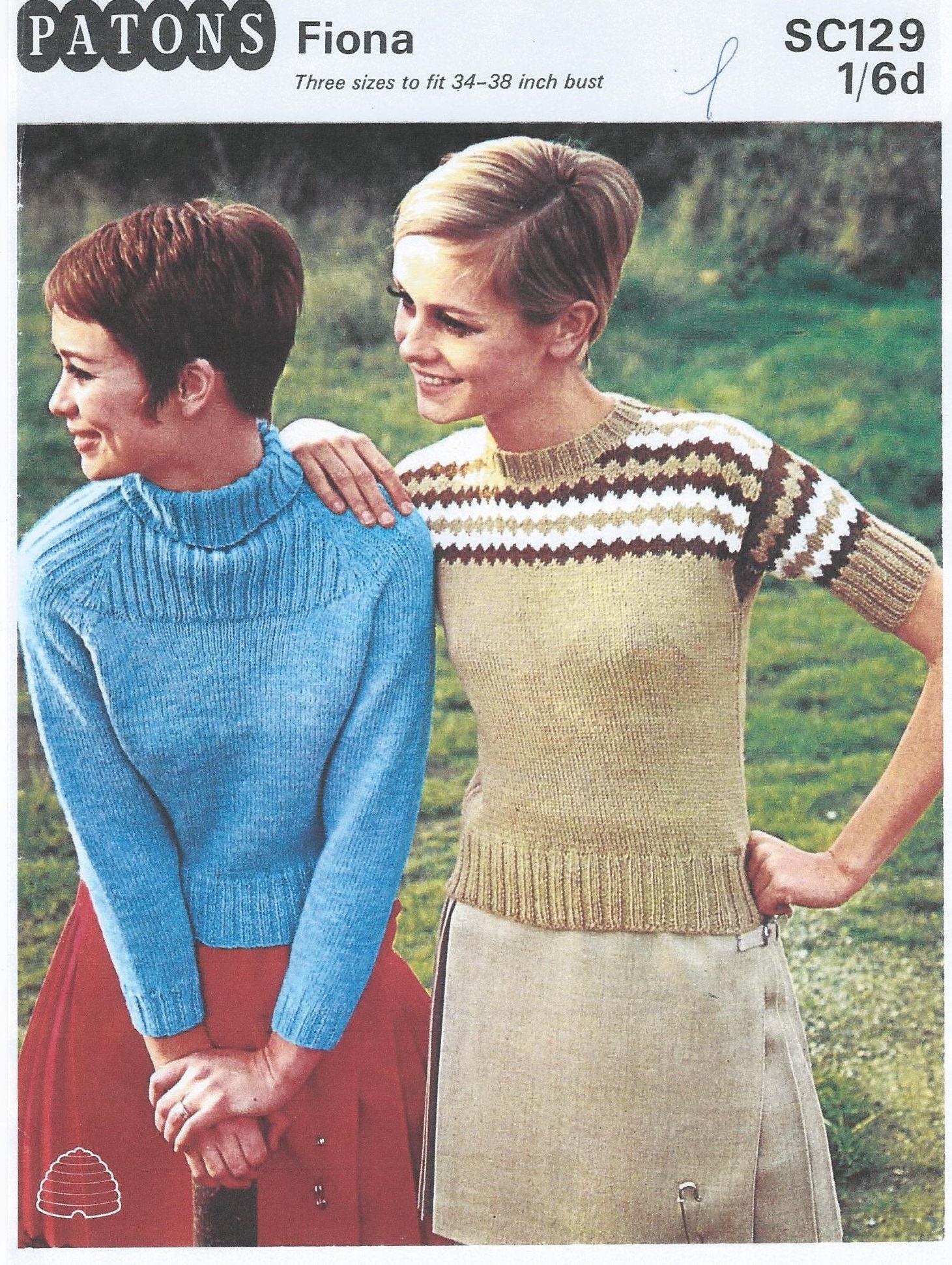 Front of Patons SC129 showing two yourn ladies wearhing sweaters. One is blue with plain body and ribbed yoke and turtle neck, and the other is short sleeved, withfawn with diamond brown, fawn and white yoke and round neck,