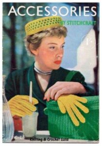 Stitchcraft 26 Lady with yellow gloves, green knitted badge and a coordinating yellow and green hat.