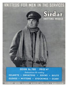 Cover of Knitteds for Men inthe Services (768) showing soldier wearing knitted scarf. Instructions for making helmets, sweaters, socks, belts, gloves, mittens, stockings, scarf