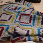 Afghan blanket made from corner-to-corner crochet squares.