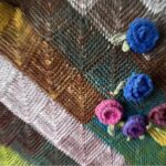 Patchwork knitting embellished with flowers