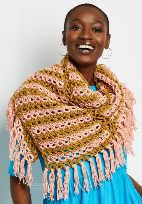 Model wearing a broomstick crochet shawl.