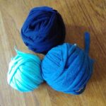 Three blue balls of yarn made from old T-shirts.