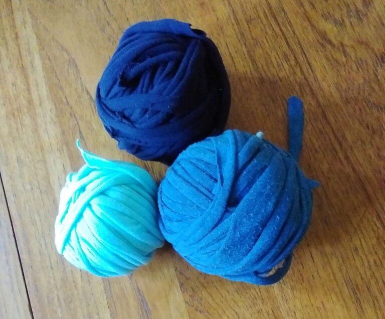 Three blue balls of yarn made from old T-shirts.