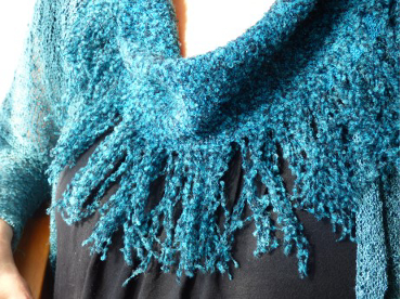 Cowl with long fringes.