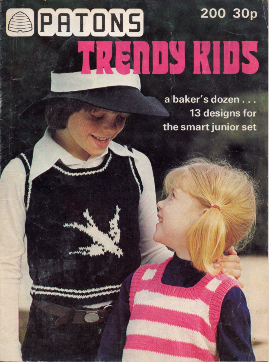 Cover of Patons 200 - Trendy Kids. Shows 2 girls, one searing a black and white tank top with a white bird motif, and the other a pink and white striped tank top.