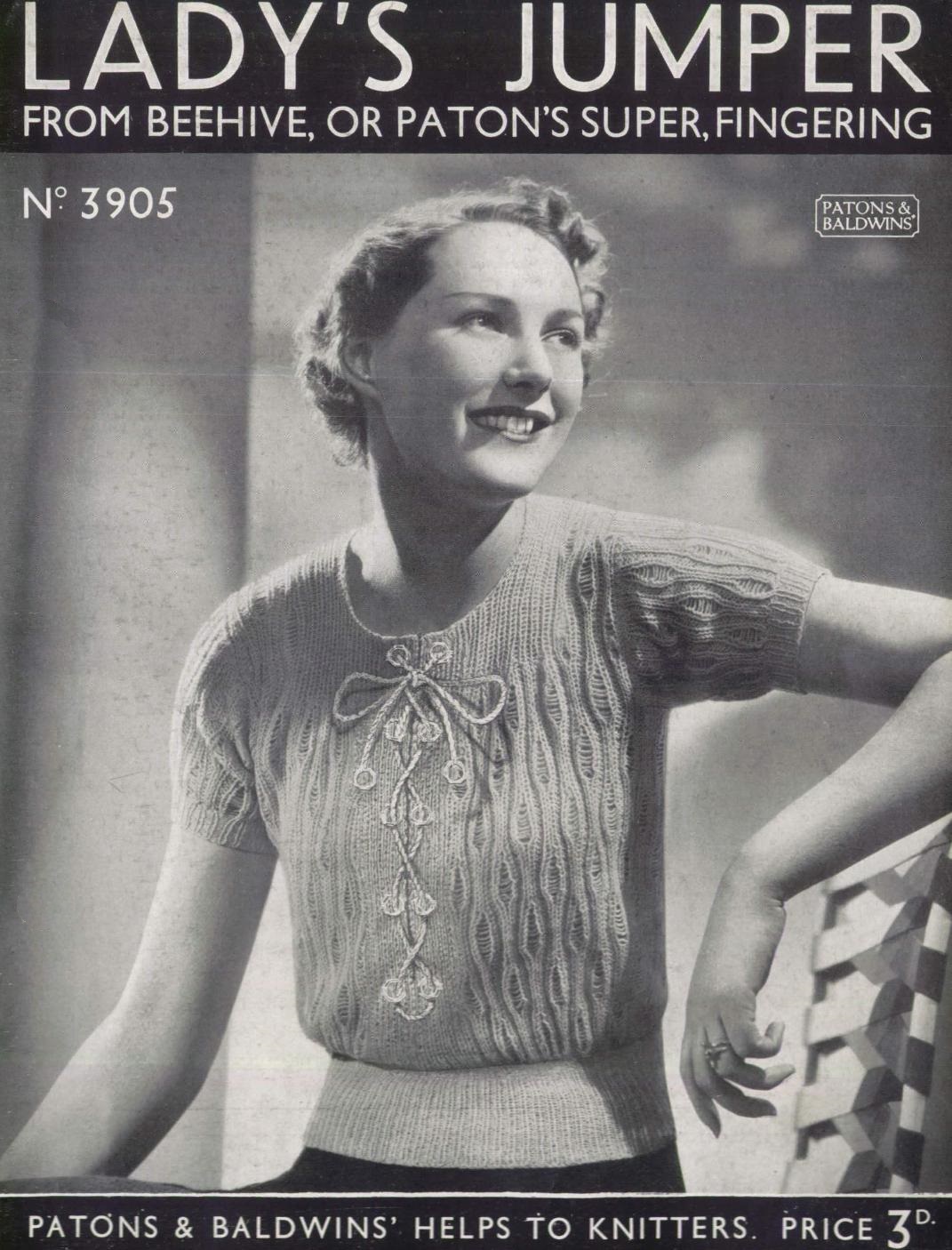 Cover of Patons & Baldwins Helps to Knitters No 3905 - Lady's jumber from Beehive or Patons super, fingering. SHows lady wearing short sleeved jumper with cabled design with featured lace tie at front.