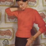 Cover of Patons pattern C-450 - in P&B wools of 3-ply weight, 34-36 in bust. Showing lady wearing bright red three-quarter sleeve jumper with high ribbed neck that grows from V-shape.
