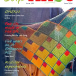 Cover of Slipknot 183 (June 2024) showing a shawl made by a Guld member using Modular Knitting. The design is made using squares (using graduated colours), each with a smaller square inside one corner, separated by thin lines of a single colour.