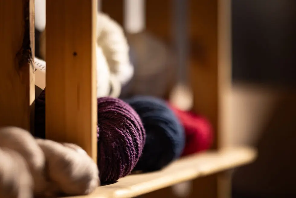 Shelving with balls of yarn.