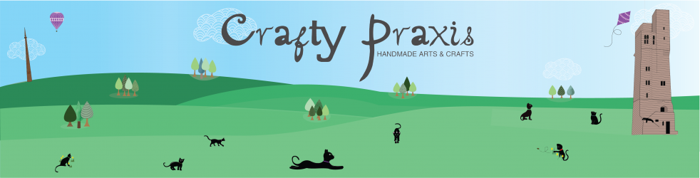 Logo of Crafty Praxis Yarns - cats in field with ruined tower, kite and hot air balloon. Text: Crafty Praxis; handmade crafts and craft