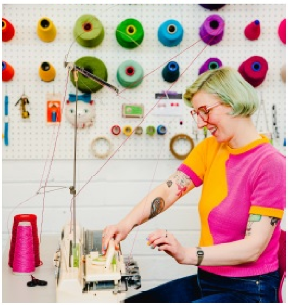 Photo of Kandy Diamond using a knitting machine.