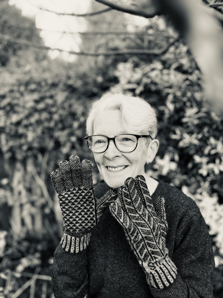 Photograph of Angharad Thomas wearing knitted gloves