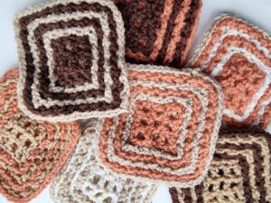 An assortment of crochet Double Granny Squares (a form of Double Filet crochet).