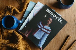 Front cover of Moorit Magazine issue 3 showing lady wearing an asymmetric striped pullover.