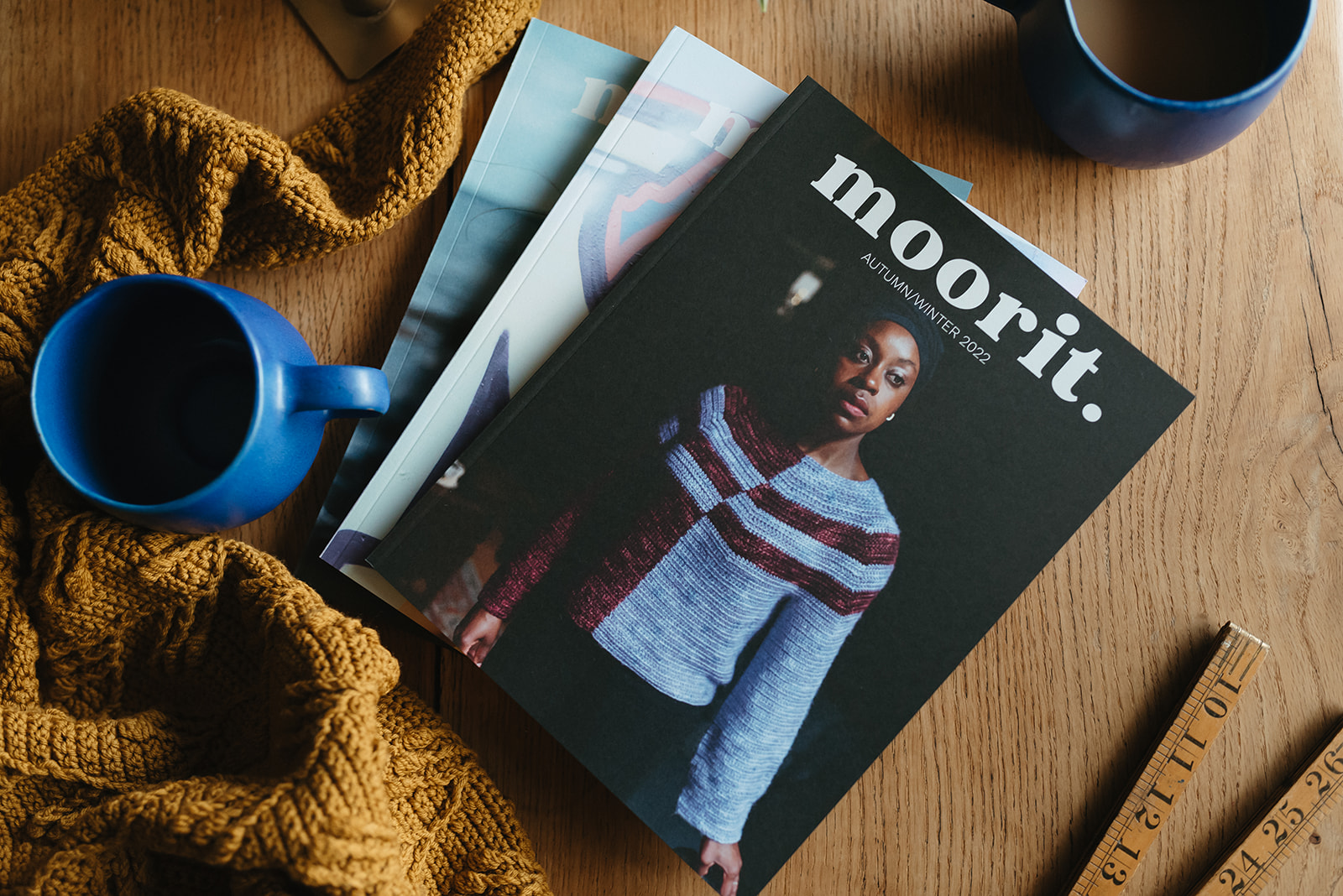 Front cover of Moorit Magazine issue 3 showing lady wearing an asymmetric striped pullover.